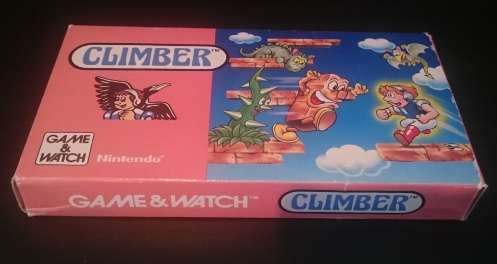 Boîte du Game & Watch Climber, illustration rose et bleue montrant le personnage grimpant une forteresse